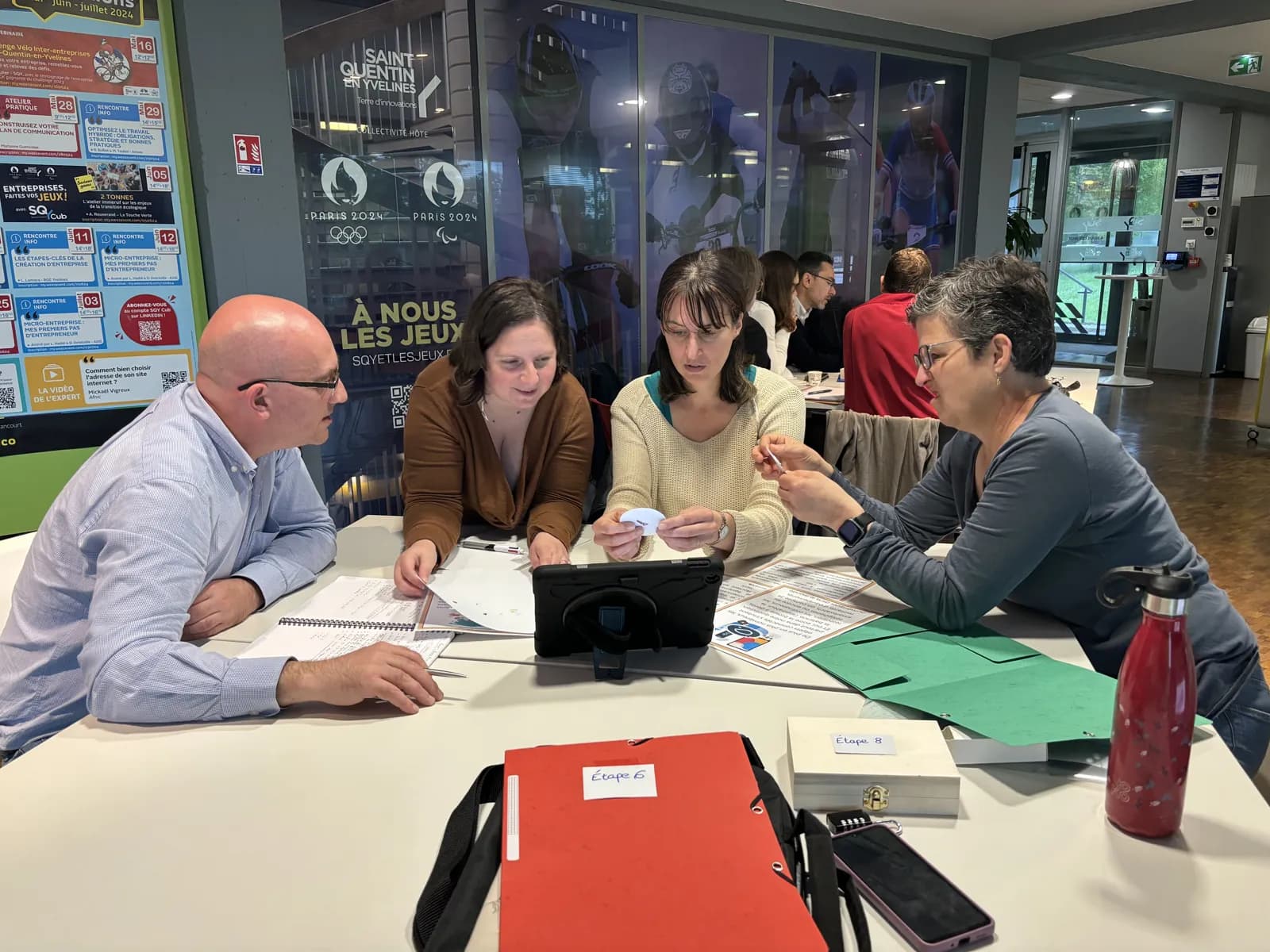 On-site corporate escape game: a team around its case, with the tablet and the clues