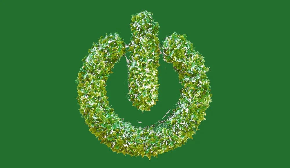 Green foliage power button on a green background, a symbol of responsible digital technology