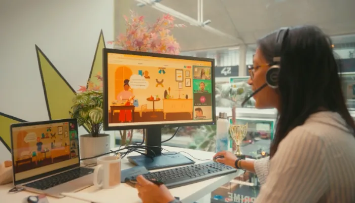 Player wearing a headset in front of an online escape game displayed on two screens